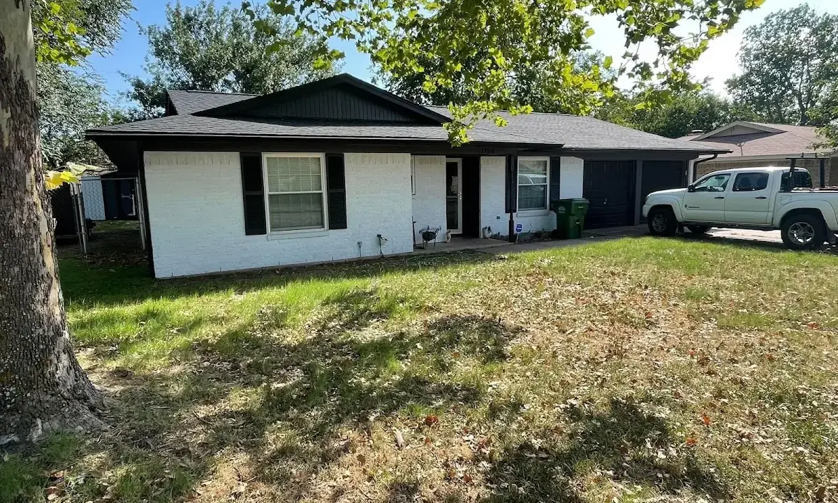 Professional roofing crew working on a residential roof in Irondale